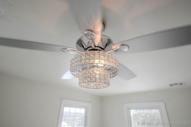 details with ceiling fan with notable chandelier