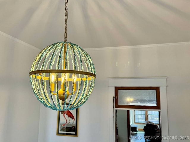 interior details featuring ornamental molding and a chandelier