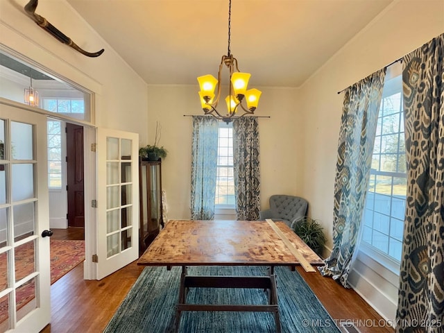 dining space featuring plenty of natural light, wood-type flooring, and a chandelier