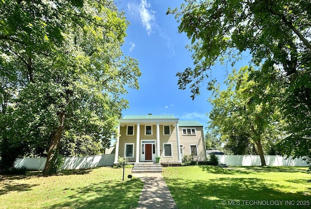 greek revival house with a front yard