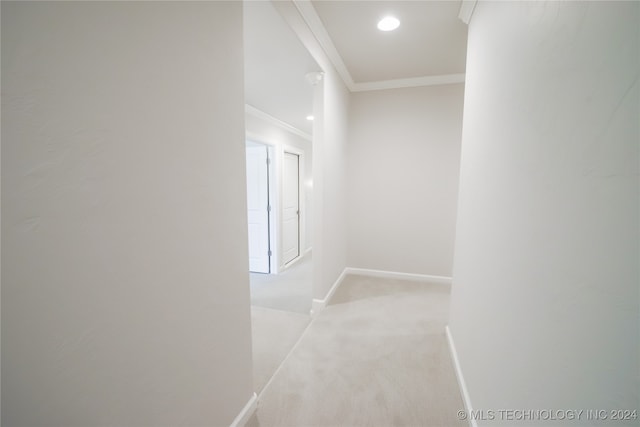 corridor featuring light colored carpet and crown molding