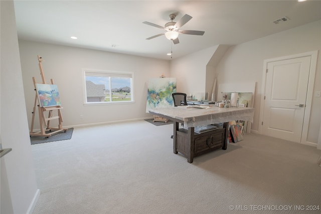 home office with light carpet and ceiling fan