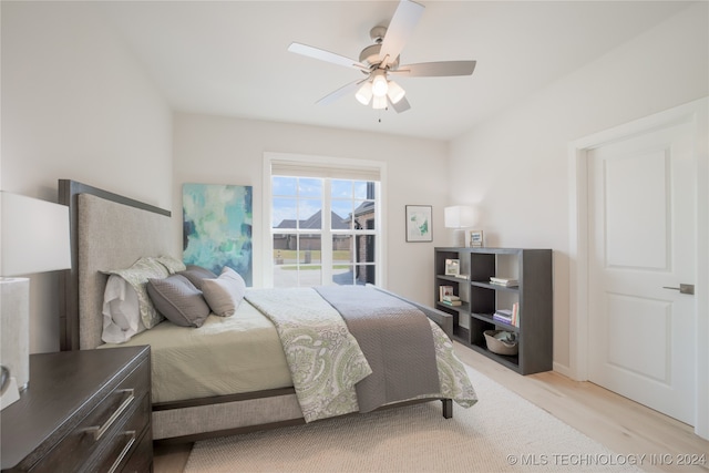 bedroom with ceiling fan and light wood-type flooring