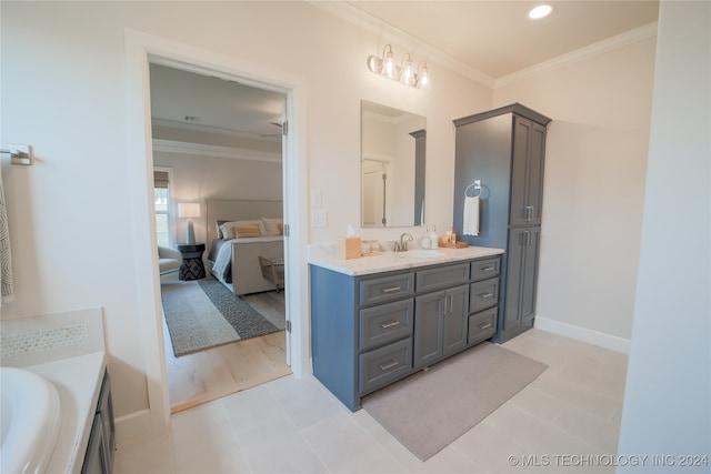 bathroom featuring ornamental molding, tile patterned flooring, and vanity