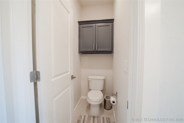 bathroom featuring toilet and tile patterned floors