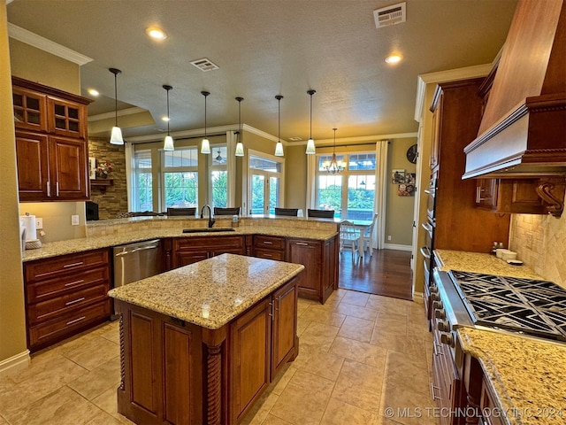 kitchen featuring ornamental molding, a kitchen island, light stone countertops, and stainless steel appliances