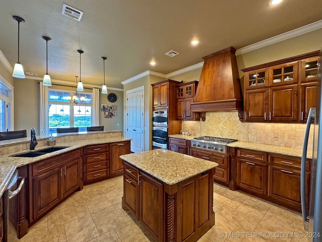 kitchen featuring hanging light fixtures, stainless steel appliances, crown molding, premium range hood, and sink