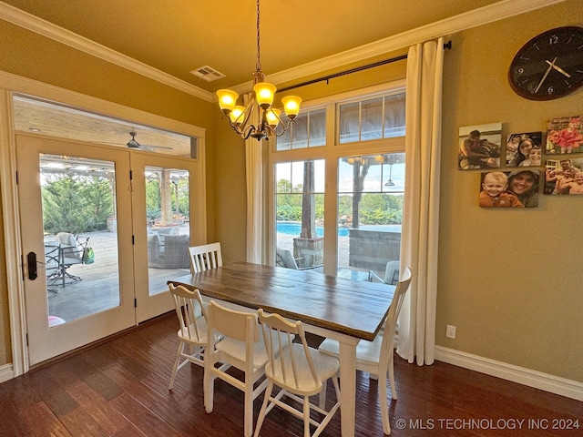 dining room with ornamental molding, a chandelier, dark hardwood / wood-style floors, and french doors