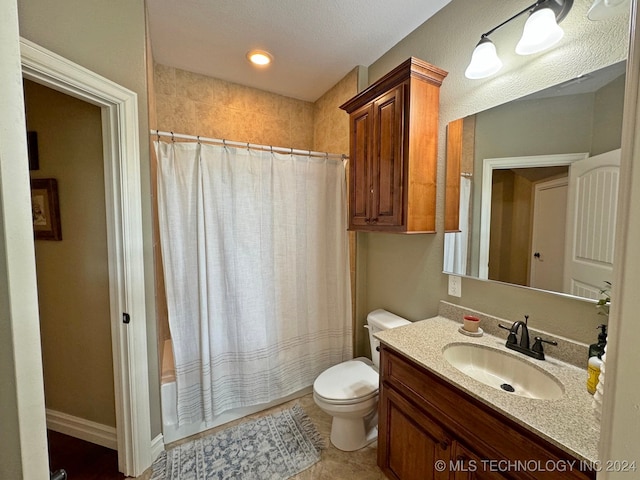 full bathroom featuring shower / tub combo, vanity, a textured ceiling, tile patterned flooring, and toilet