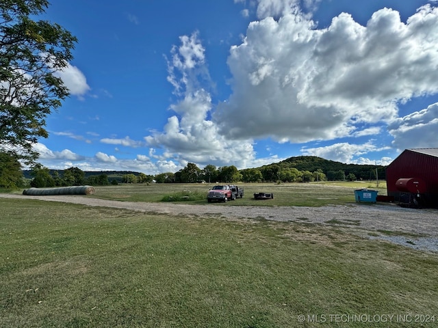 view of yard with a rural view