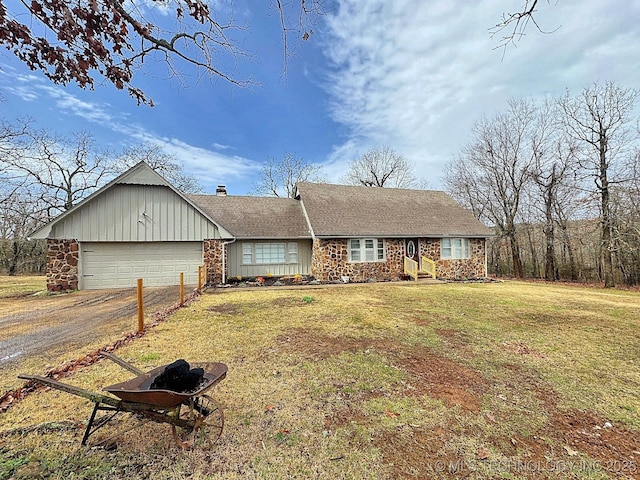 ranch-style home with a garage, driveway, board and batten siding, a front lawn, and a chimney