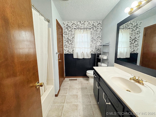 full bath with visible vents, toilet, a textured ceiling, vanity, and tile patterned flooring