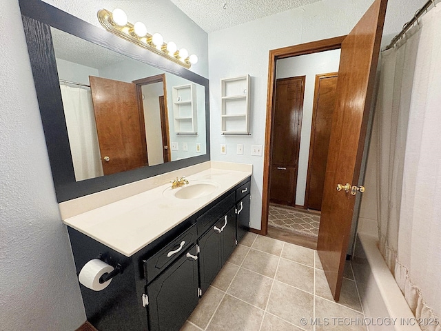 bathroom featuring a textured ceiling, tile patterned flooring, vanity, and a shower with curtain