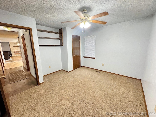 unfurnished bedroom with carpet floors, a closet, visible vents, a textured ceiling, and baseboards