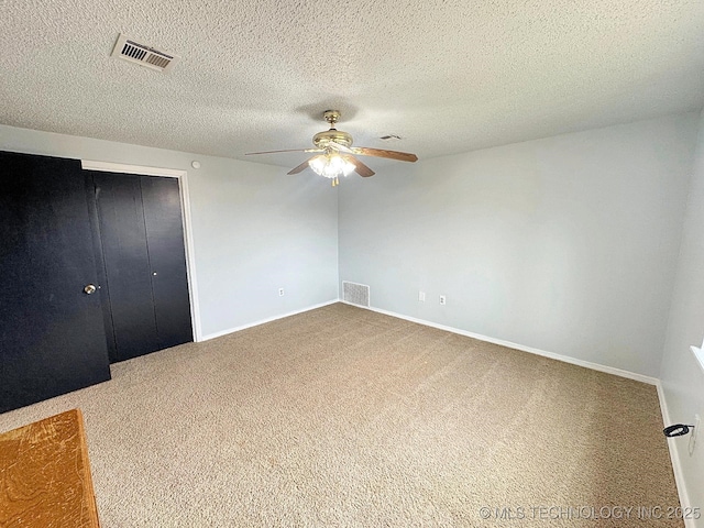 unfurnished bedroom featuring baseboards, carpet, visible vents, and a closet