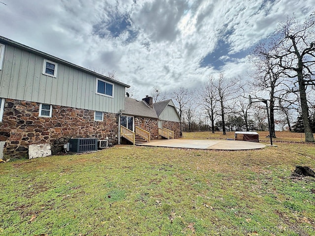 view of yard featuring central AC and a patio area