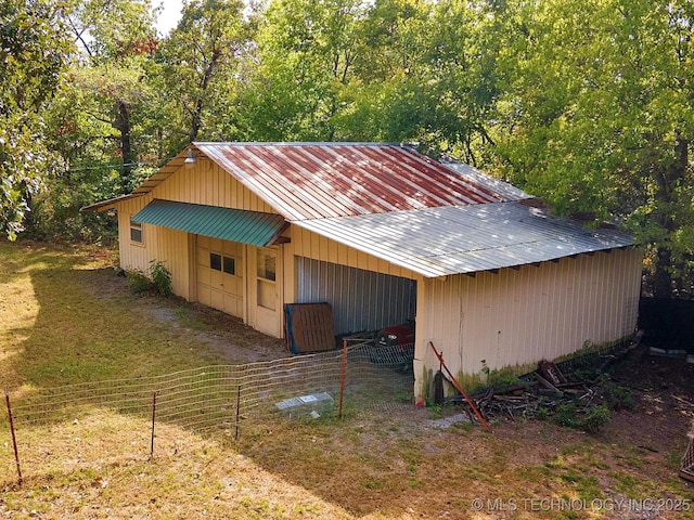 view of pole building with fence