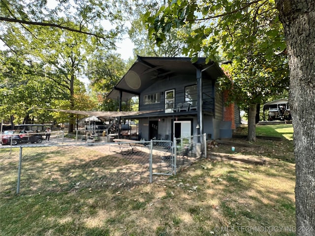 rear view of property with a lawn