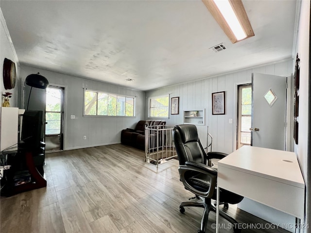 home office with light hardwood / wood-style floors