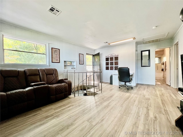 living room with light hardwood / wood-style flooring and ornamental molding