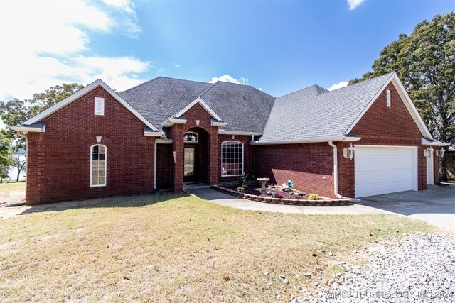 view of front of property with a garage and a front lawn