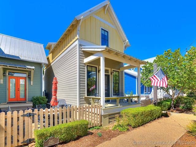 view of front of property with covered porch and french doors