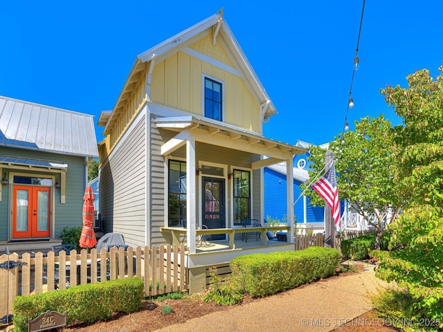 view of front of home with french doors and a porch