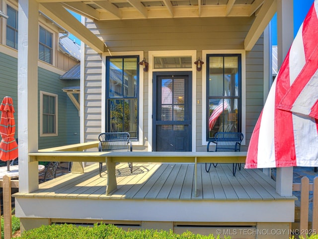 wooden terrace featuring covered porch