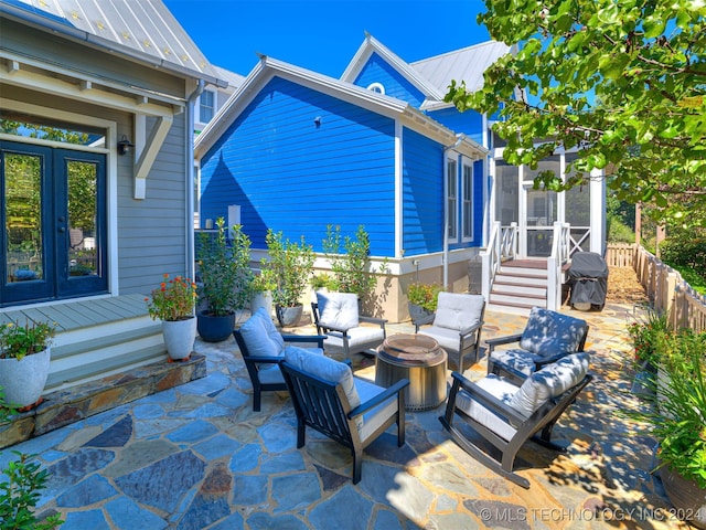 view of patio featuring a grill, an outdoor living space with a fire pit, and french doors