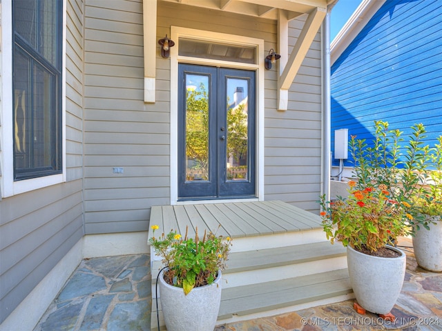 view of exterior entry featuring french doors