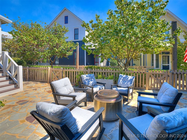 view of patio featuring an outdoor living space with a fire pit