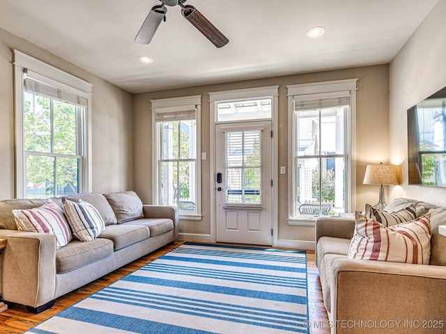 living room featuring hardwood / wood-style flooring and ceiling fan