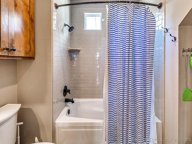 bathroom with shower / bath combo and toilet