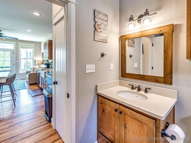 bathroom featuring ceiling fan, vanity, and hardwood / wood-style floors