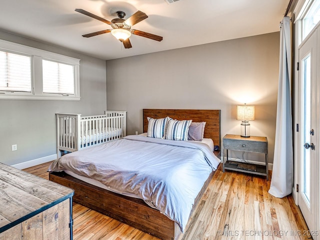 bedroom with ceiling fan and light hardwood / wood-style floors