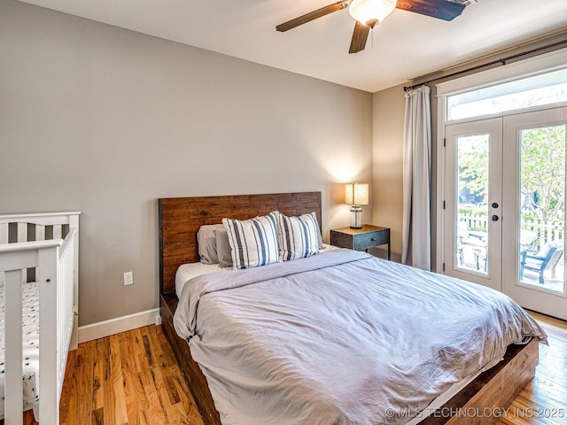 bedroom with access to exterior, hardwood / wood-style flooring, french doors, and ceiling fan