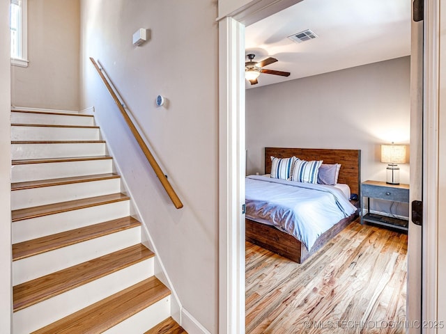 bedroom with ceiling fan and light wood-type flooring