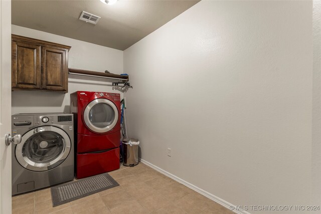 washroom featuring cabinets and independent washer and dryer