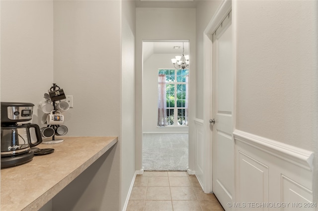 interior space with a notable chandelier and light tile patterned floors