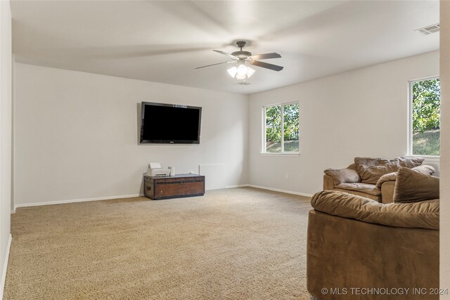 carpeted living room featuring ceiling fan