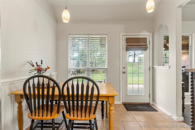 tiled dining space featuring plenty of natural light