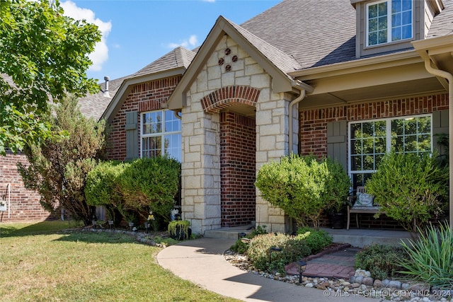 property entrance with a lawn