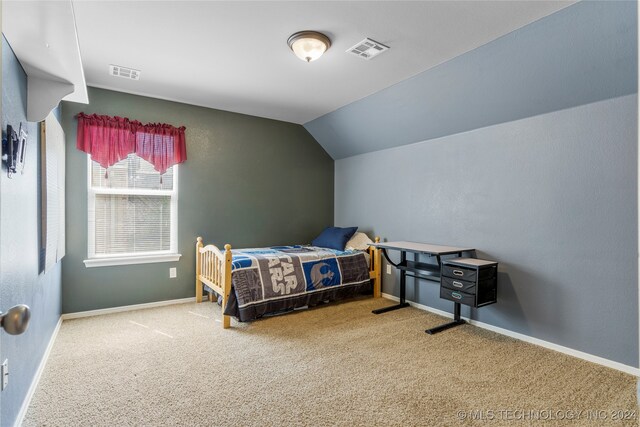 bedroom with vaulted ceiling and carpet floors