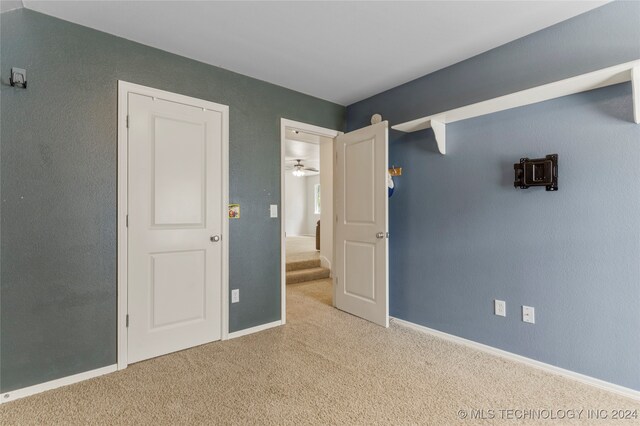 unfurnished bedroom with light colored carpet