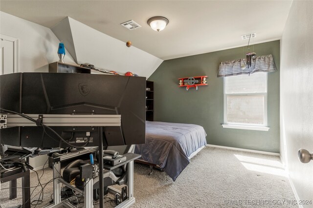 bedroom with carpet flooring and lofted ceiling