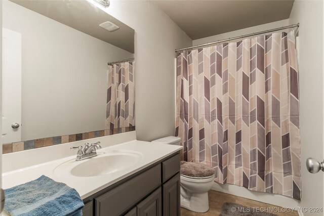 bathroom with vanity, toilet, and walk in shower