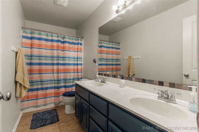 bathroom with vanity, a shower with curtain, toilet, and tile patterned flooring