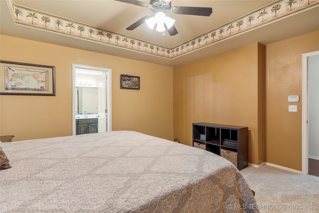 carpeted bedroom featuring ceiling fan and ensuite bathroom