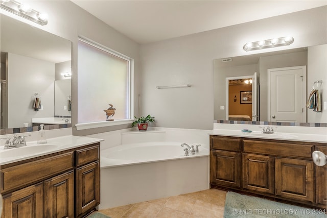 bathroom with vanity, a tub to relax in, and tile patterned floors