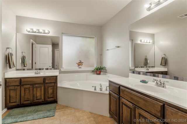 bathroom with vanity, tile patterned floors, and a washtub